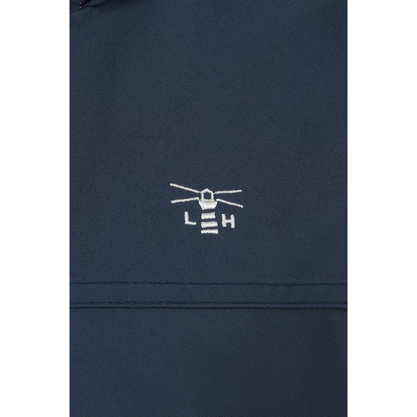 Close-up view of the logo and fabric of a women's Lighthouse Beachcomber II waterproof jacket in Navy.