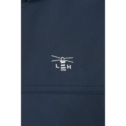 Close-up view of the logo and fabric of a women's Lighthouse Beachcomber II waterproof jacket in Navy.