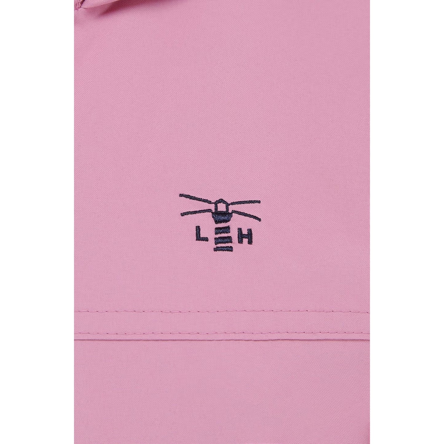 Close-up view of the embroidered logo and fabric of a womens Beachcomber II waterproof jacket in Pink.