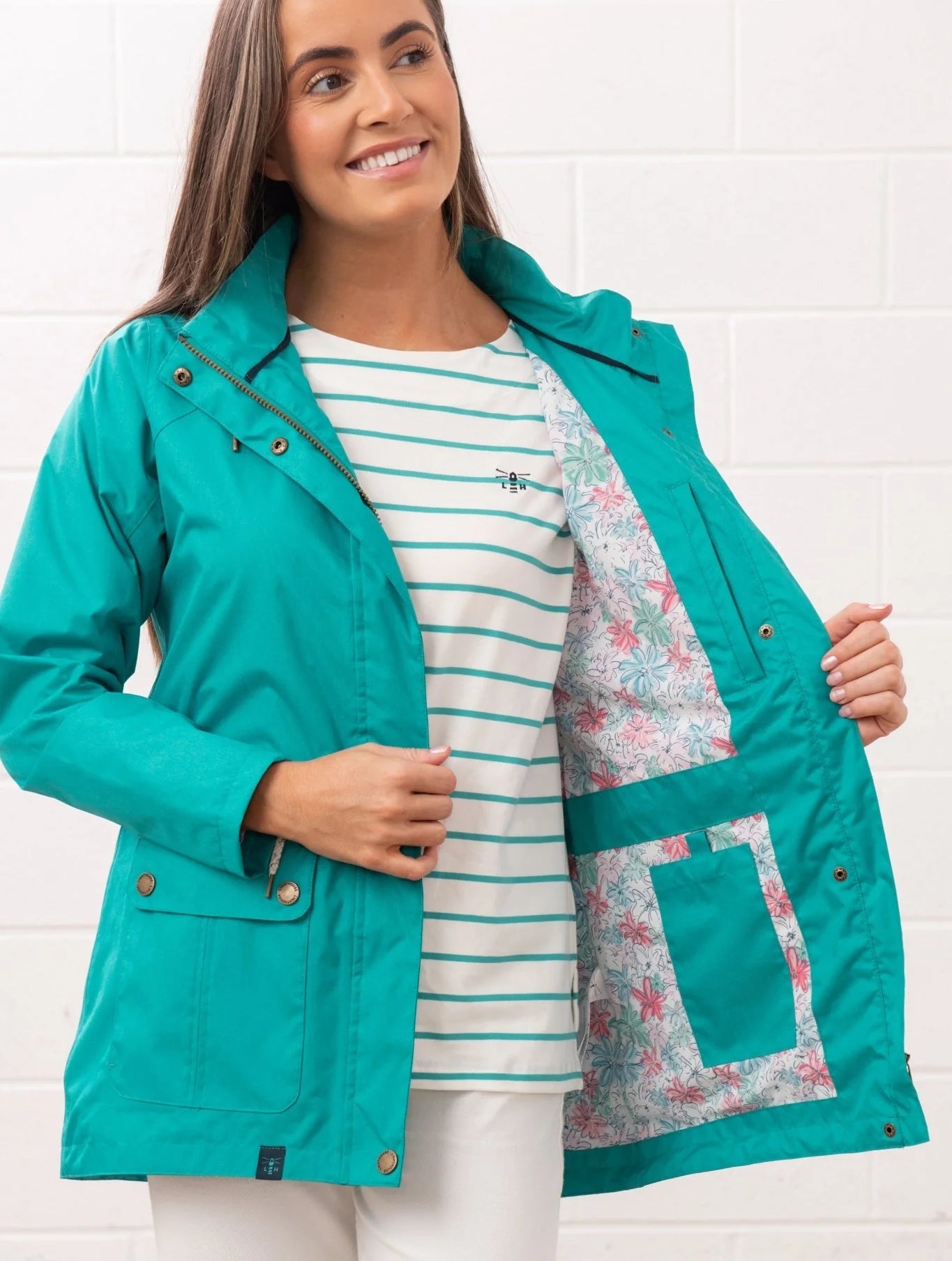 Lighthouse teal womens waterproof jacket open to show floral inner lining with front pockets