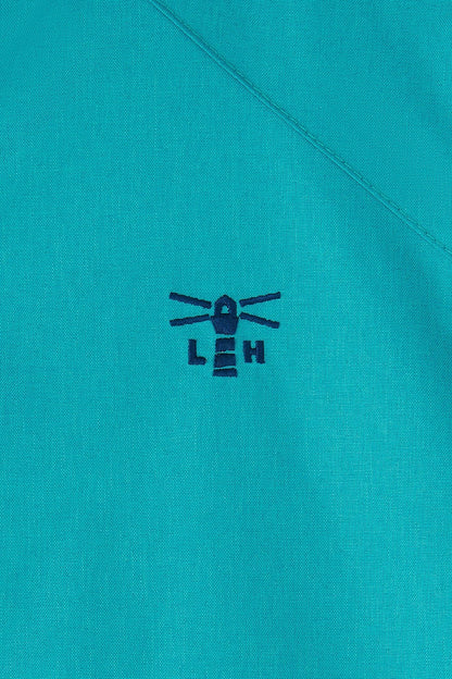 Close-up of Lighthouse teal womens waterproof jacket fabric with stitched lighthouse logo