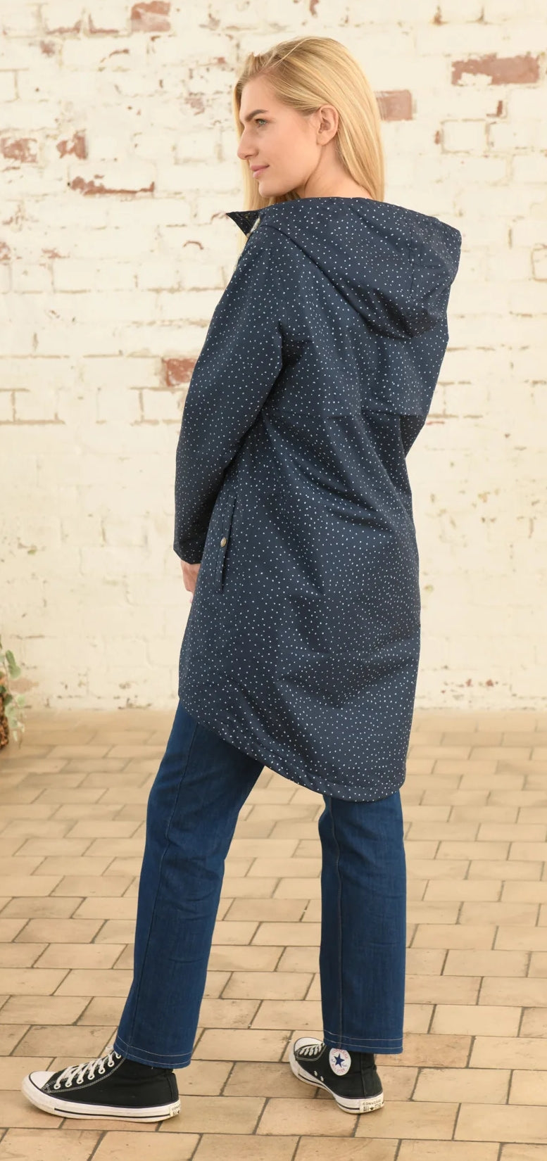 Lighthouse womens beachcomber jacket navy dot shown on model from back with hood and long fit