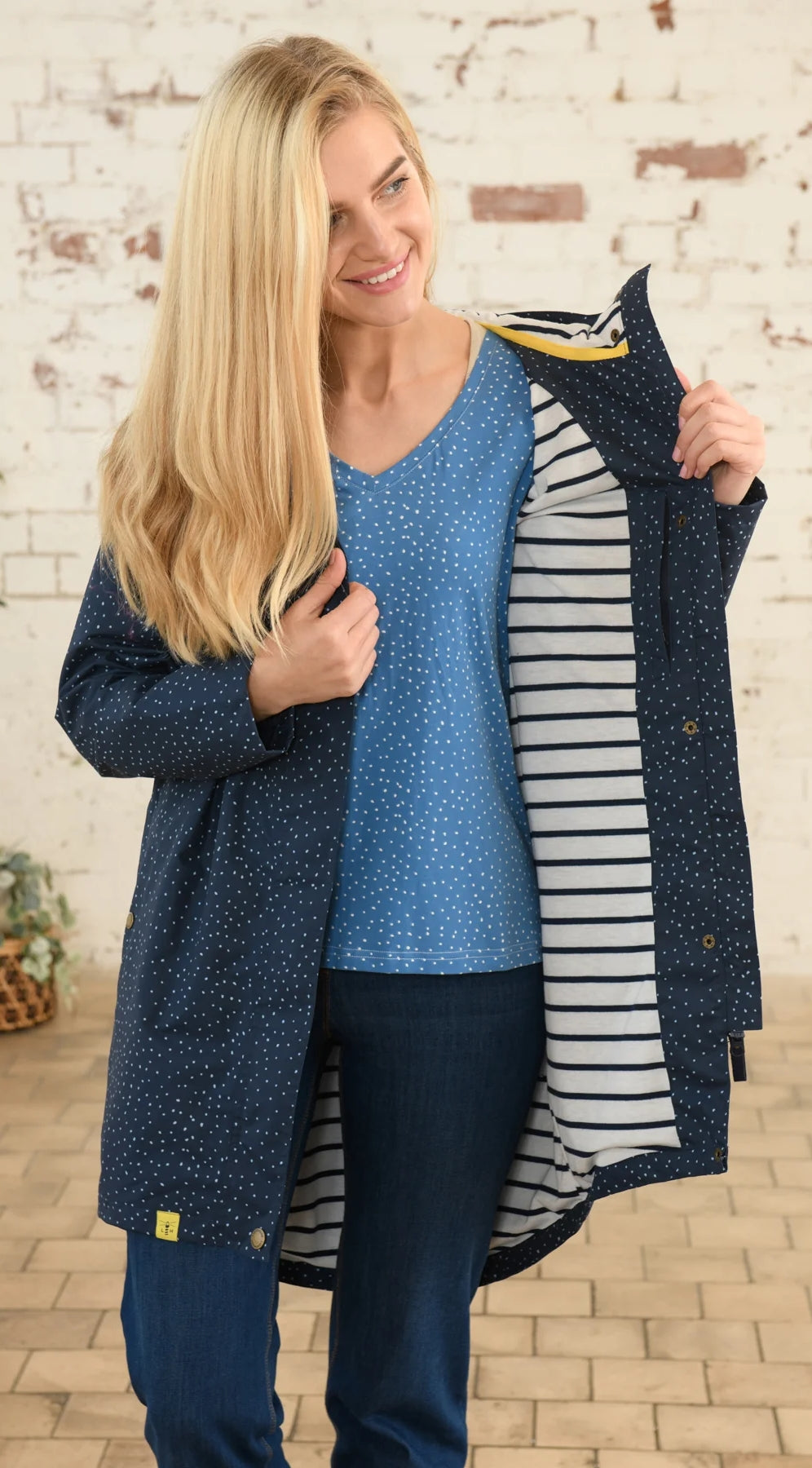 Lighthouse womens beachcomber jacket navy dot with striped inner lining worn by smiling woman