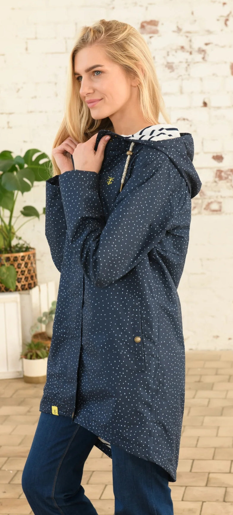 Lighthouse womens beachcomber jacket navy dot with hood and zip front worn by woman indoors