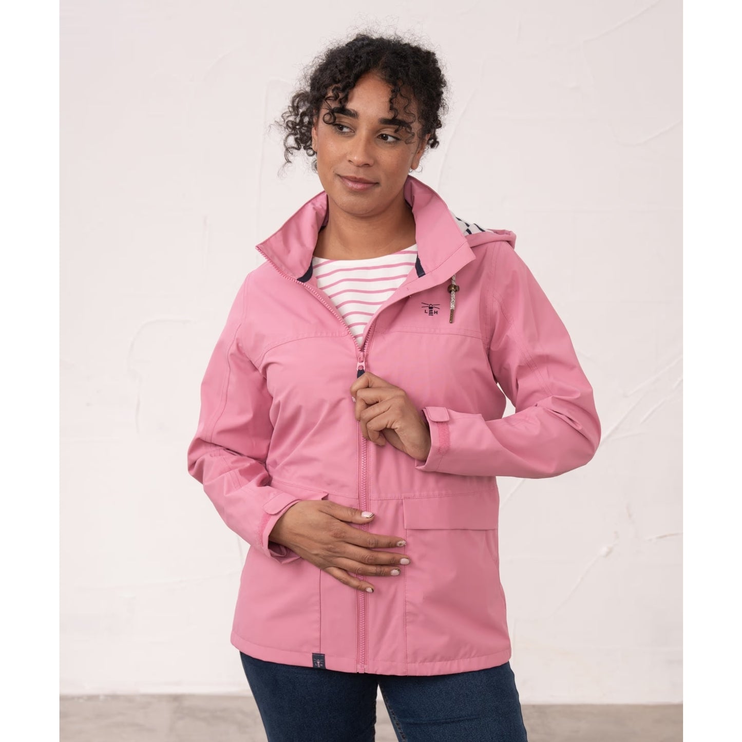 Front view of a woman wearing a Beachcomber II waterproof jacket in Pink.