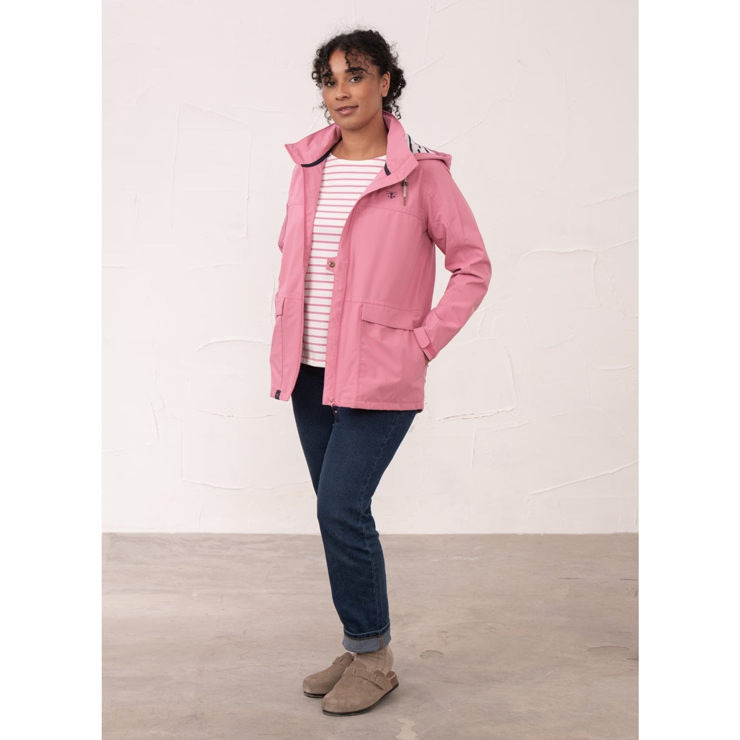 A woman wearing a Beachcomber II waterproof jacket in Pink unzipped.