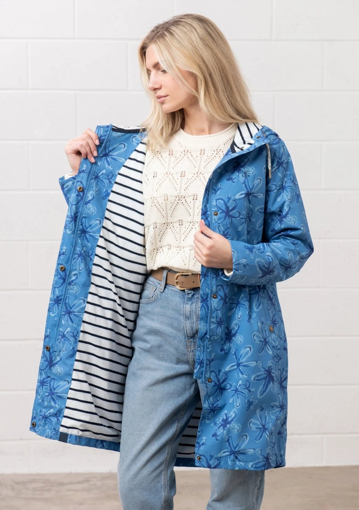 Lighthouse Womens blue floral jacket with hood and striped lining worn over casual outfit
