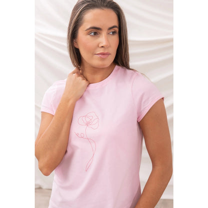 Woman wearing a pink Lighthouse Causeway t-shirt with a flower print against a white background