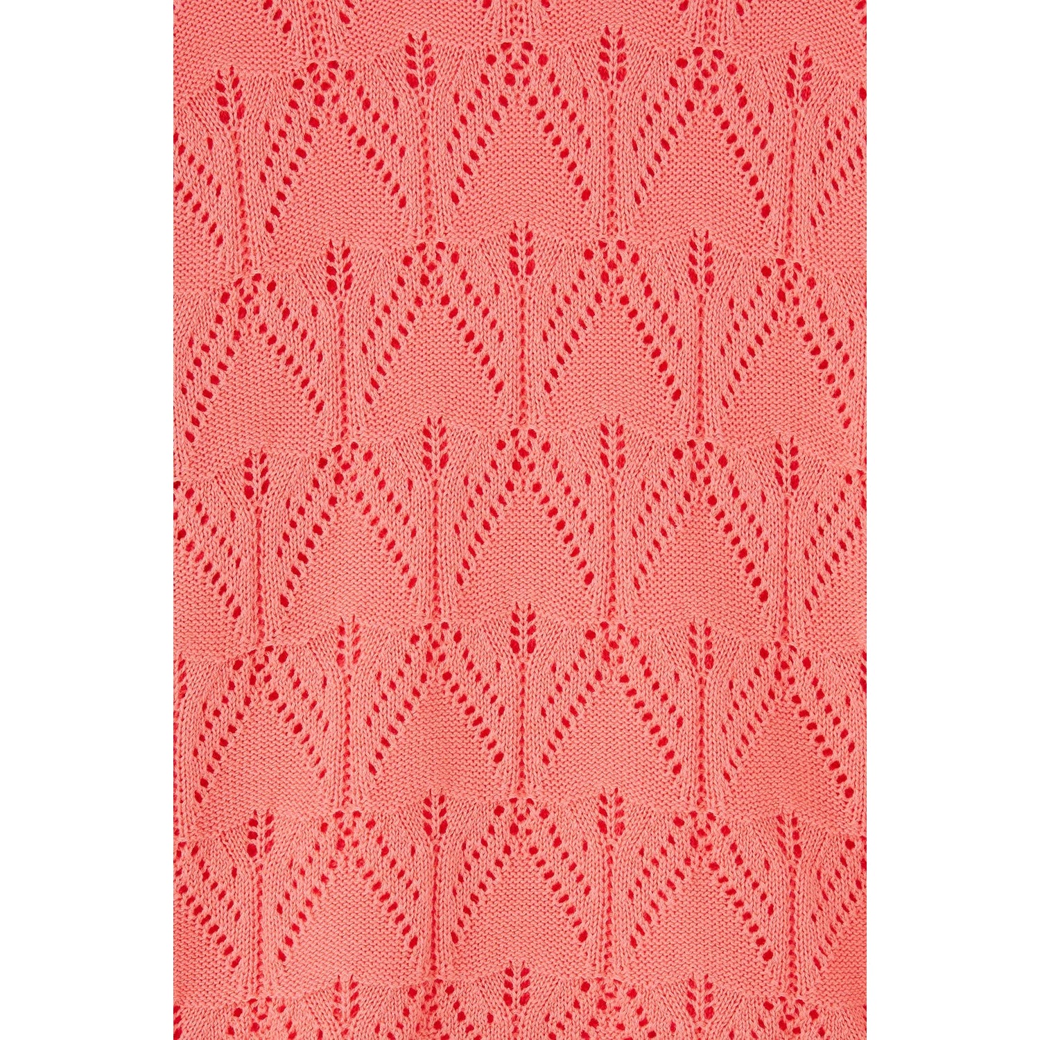 Close-up view of the pointelle crochet style knit of a womens Lighthouse Eden jumper in a bright Sugar Coral colour.