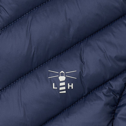 Close-up of a navy blue Lighthouse Laurel padded gilet with a logo on the chest.