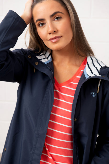 Lighthouse womens navy waterproof jacket with striped hood worn over red striped shirt
