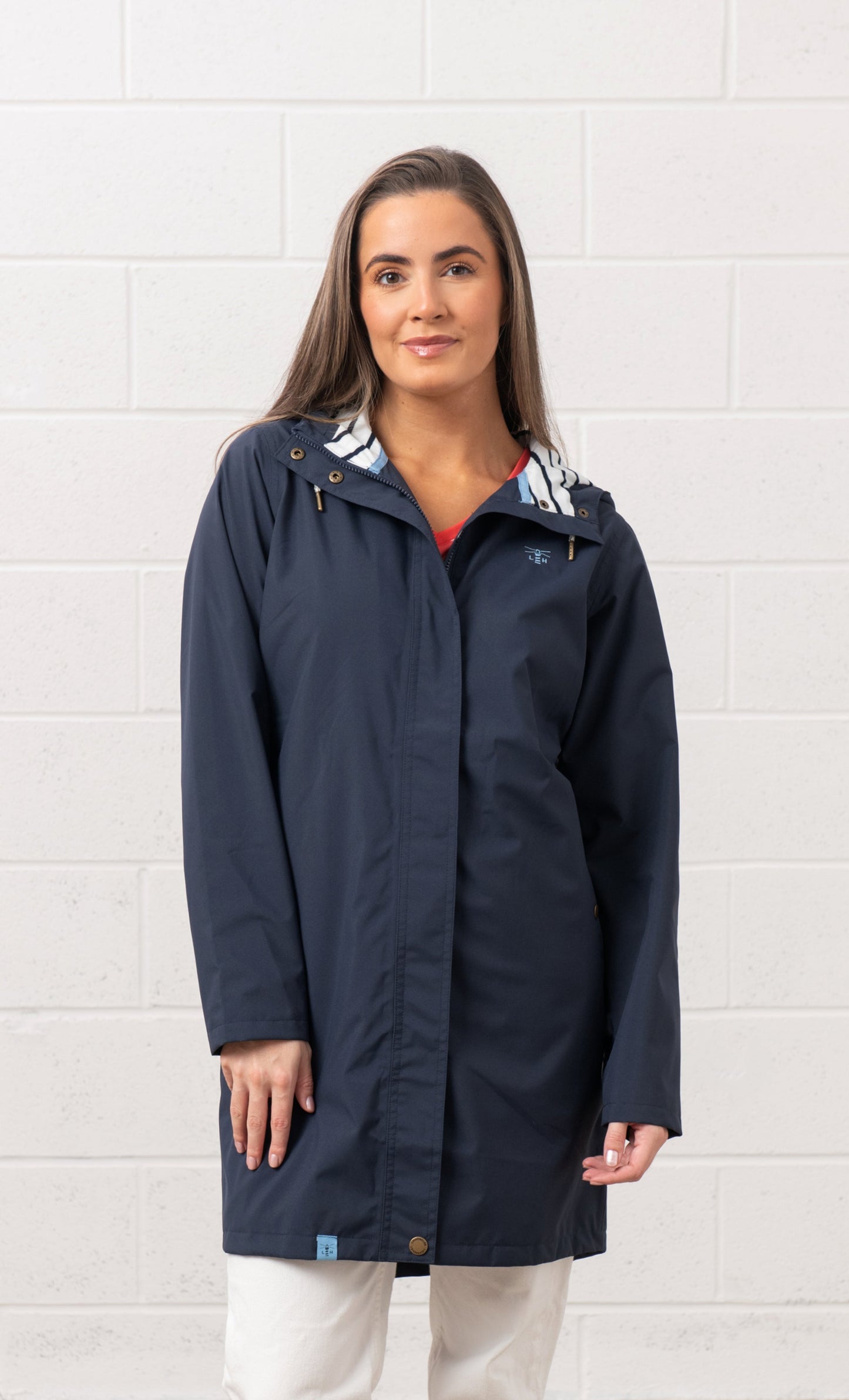 Lighthouse womens navy waterproof jacket with hood and front zipper on female model