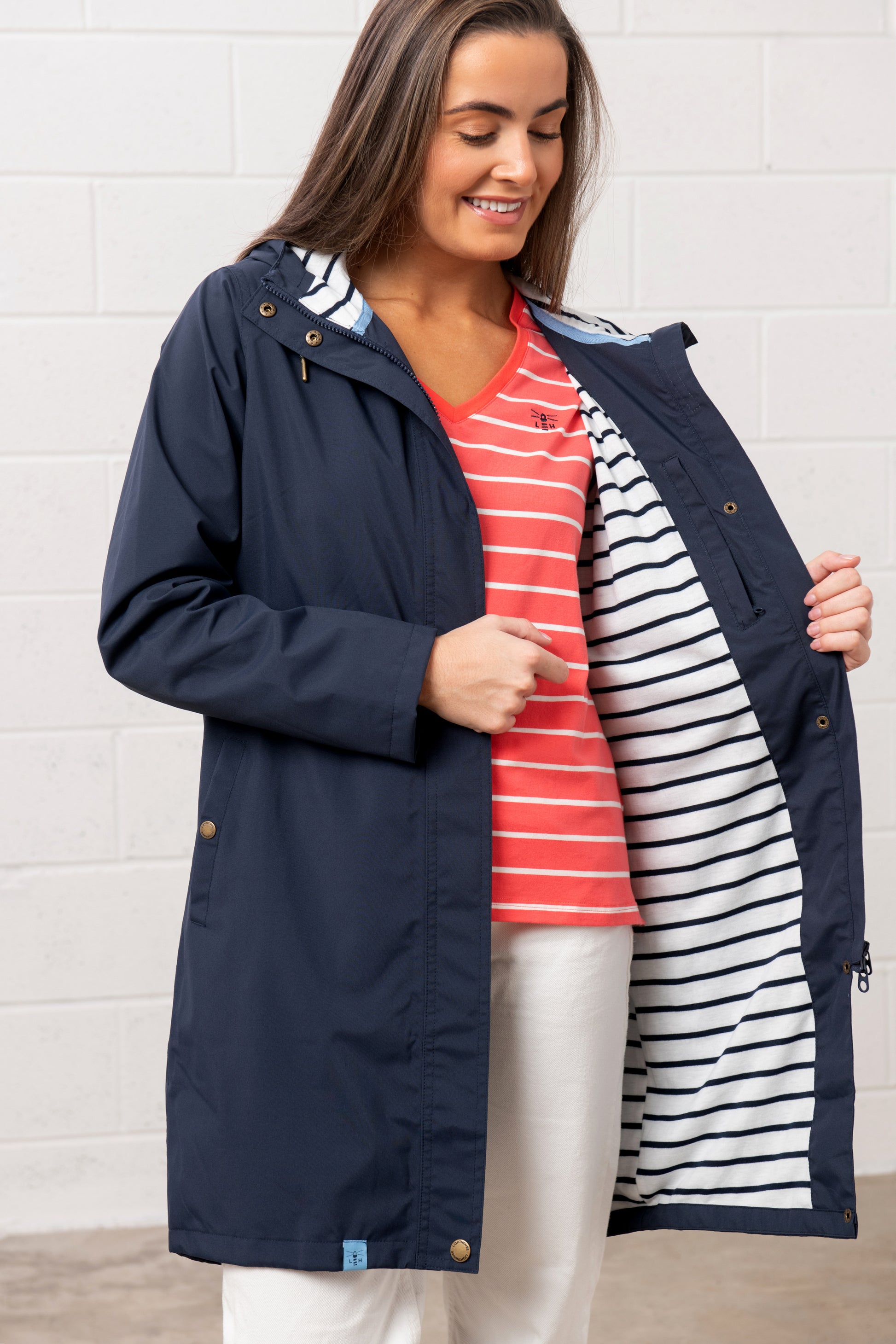 Lighthouse womens navy waterproof jacket with striped lining open front worn by smiling woman