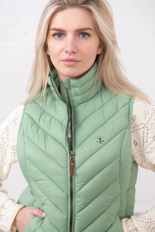 Lighthouse womens padded gilet green worn by woman with high collar and zip front