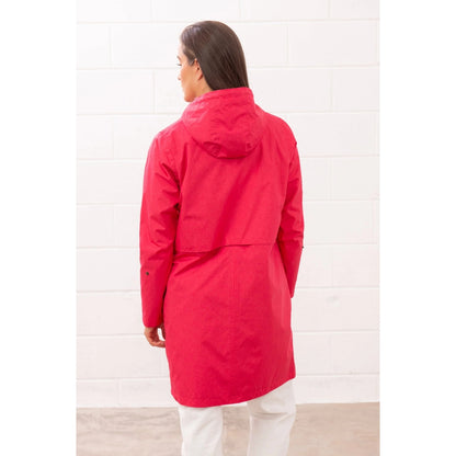 Back view of a woman wearing a Lighthouse Pippa 3/4 length waterproof raincoat in Raspberry pink/red.