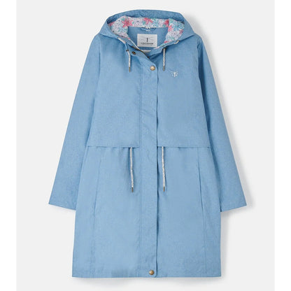 Front view of a womens Lighthouse Pippa 3/4 length waterproof raincoat in Soft Denim Blue with floral hood lining.