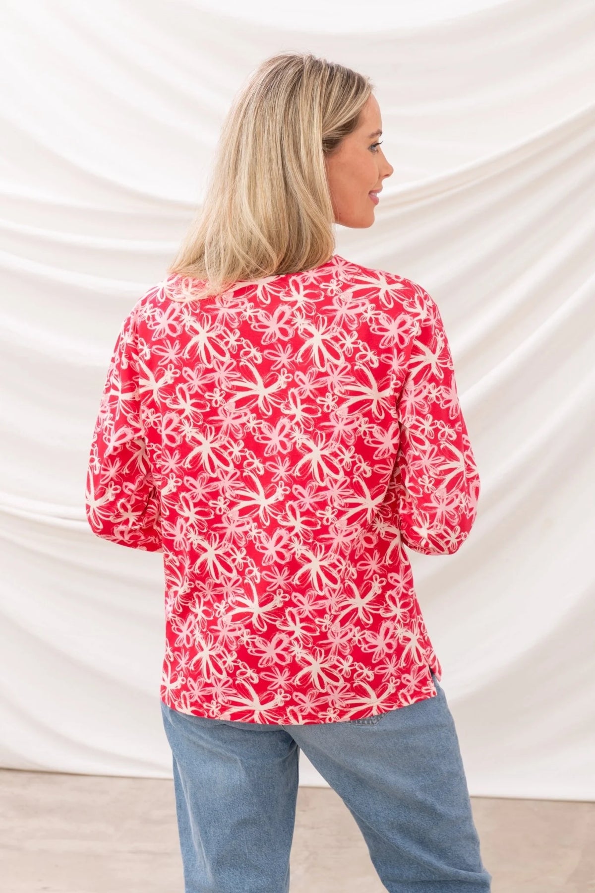 Back view of Lighthouse womens Raspberry Floral Tee with pink and white floral pattern worn with blue jeans