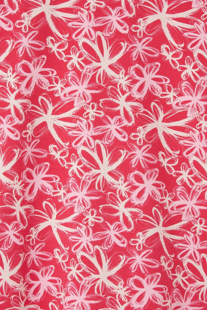 Close-up of Lighthouse womens Raspberry Floral Tee fabric with pink and white floral pattern on raspberry background