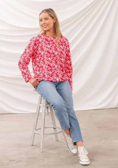 Lighthouse womens Raspberry Floral Tee worn by model sitting on stool with light wash jeans and white sneakers