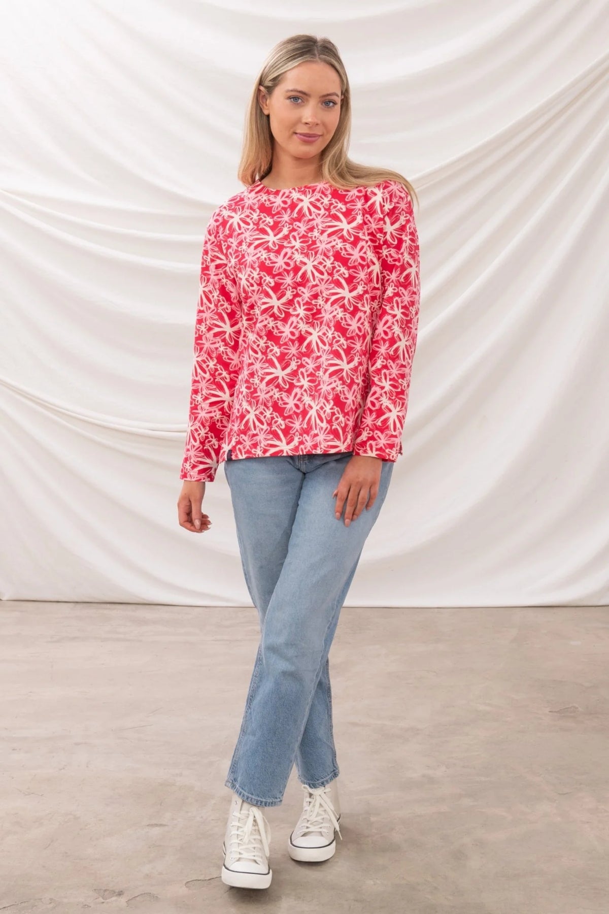 Lighthouse womens Raspberry Floral Tee with long sleeves worn by model paired with blue jeans and white sneakers