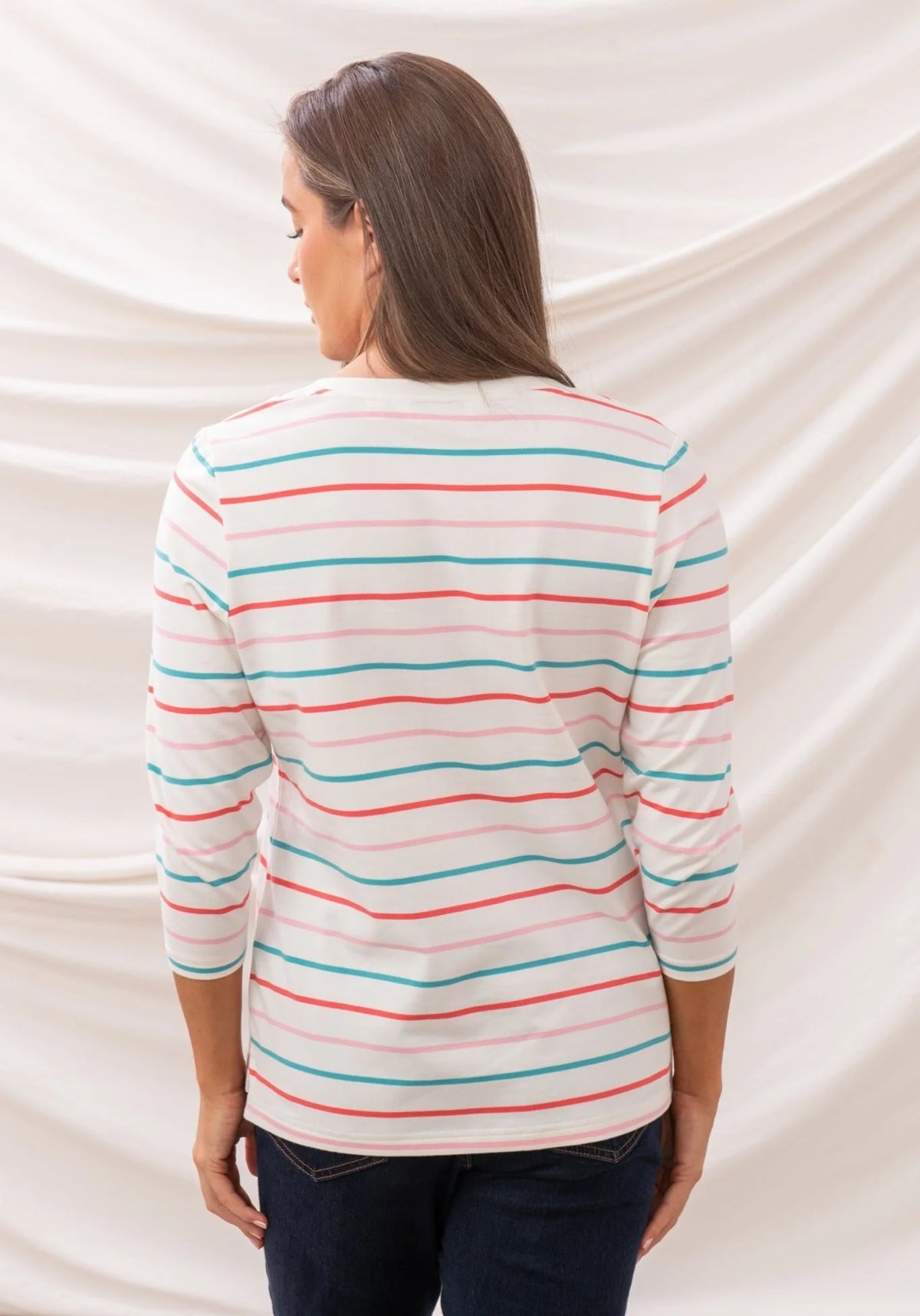 Back view of Lighthouse womens stripe v-neck top with colorful horizontal stripes on white fabric