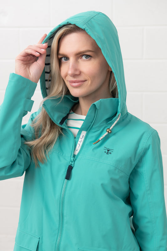 Lighthouse womens waterproof jacket teal with hood and zip front on model