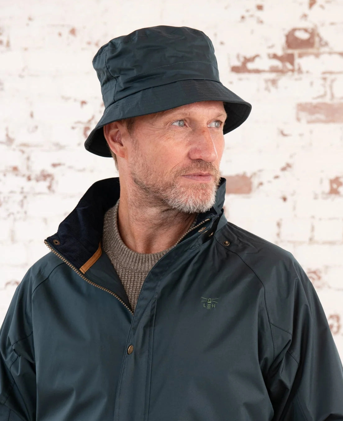 Adults York waterproof brim rain hat in Deep Night Navy with a check lining from Lighthouse.