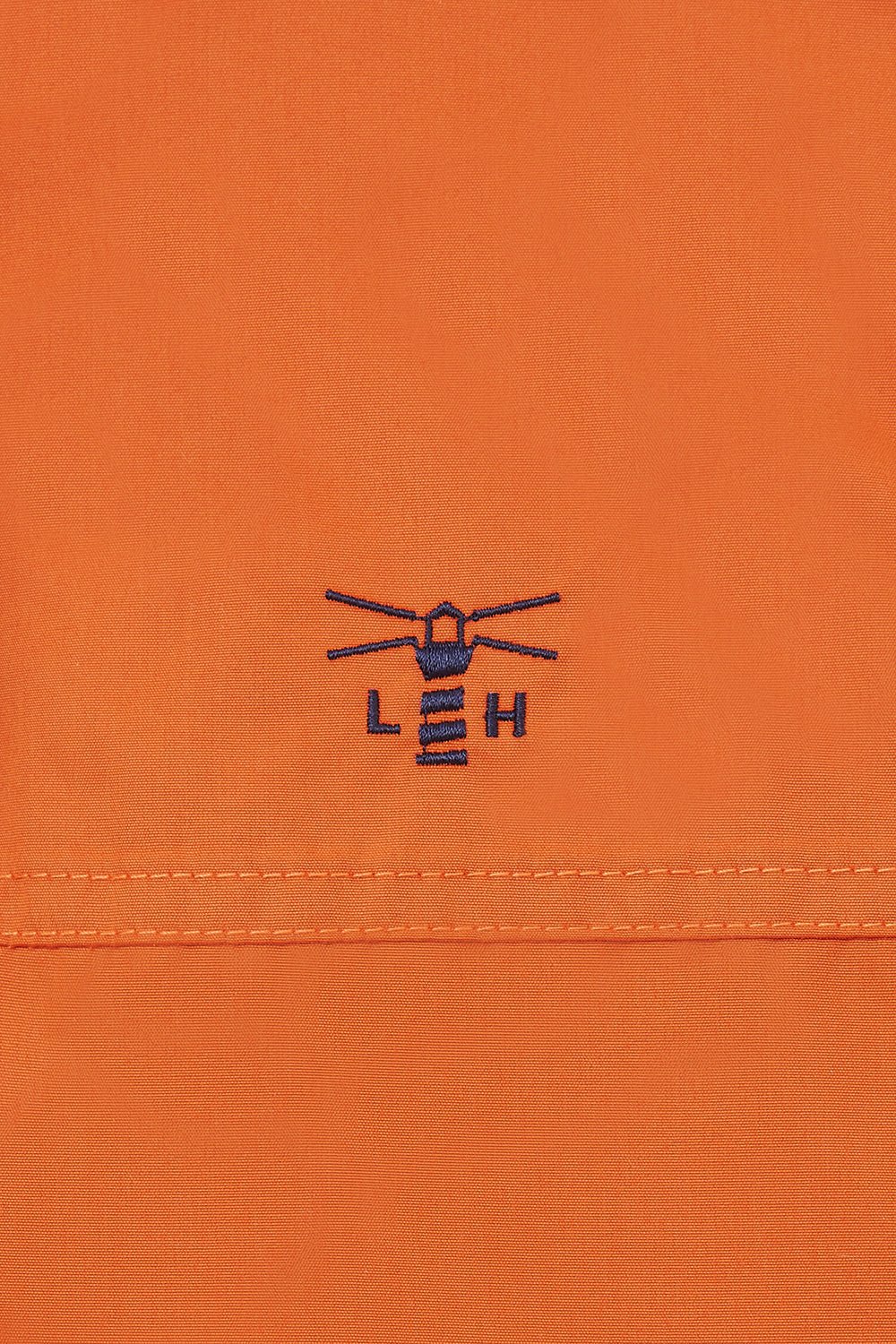 Lighthouse women's waterproof padded Eva jacket in Burnt Orange with embroidered chest logo.