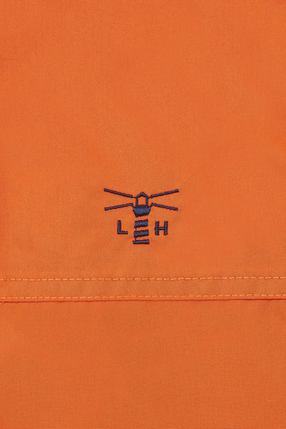 Lighthouse women's waterproof padded Eva jacket in Burnt Orange with embroidered chest logo.