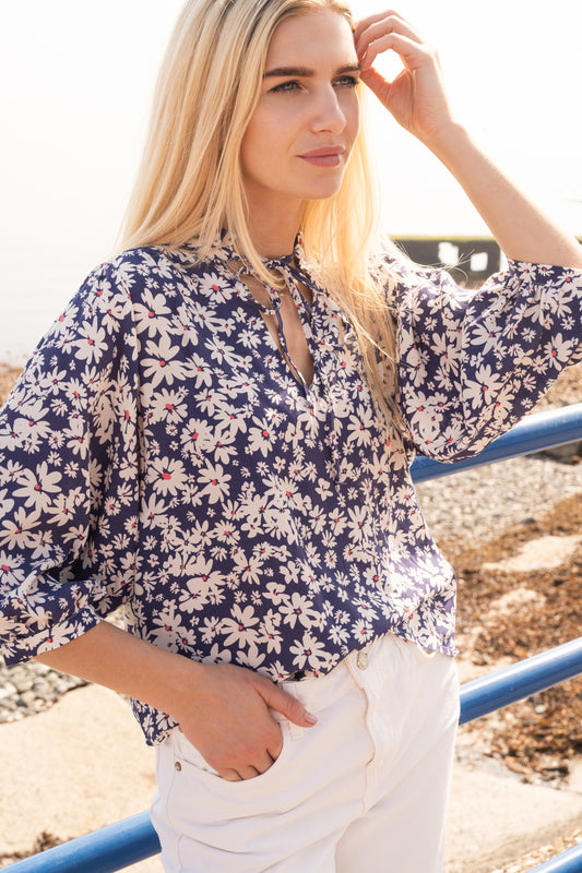 Lighthouse women's Lola blouse in indigo blue with a white and yellow floral daisy pattern.