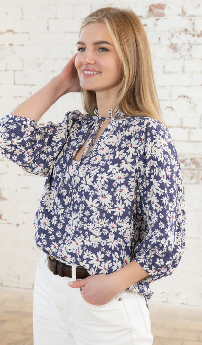 Lighthouse women's ruched neckline Lola blouse in indigo blue with a white and yellow floral daisy pattern.