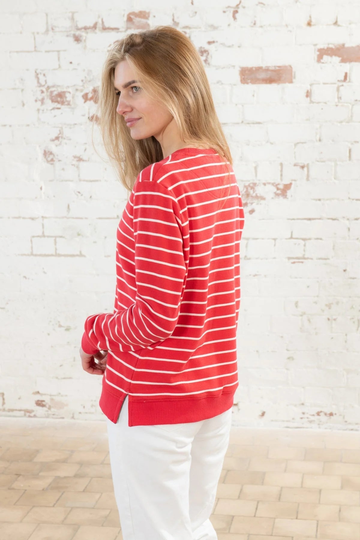 A women's crew neck Seaside sweatshirt from Lighthouse in a bright Poppy Red with thin white stripe pattern.