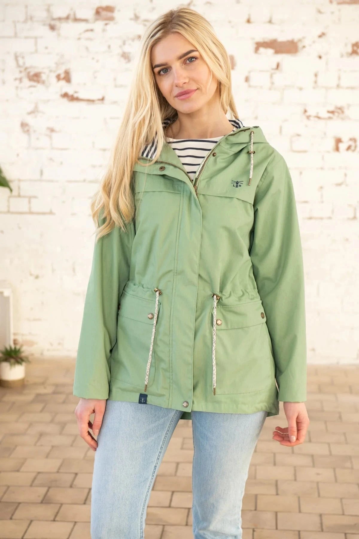 Lighthouse womens Pistachio Green Alicia waterproof jacket with drawstring waist.