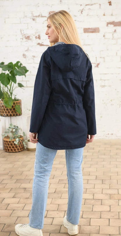 A waterproof womens hip length rain coat from Lighthouse in navy.
