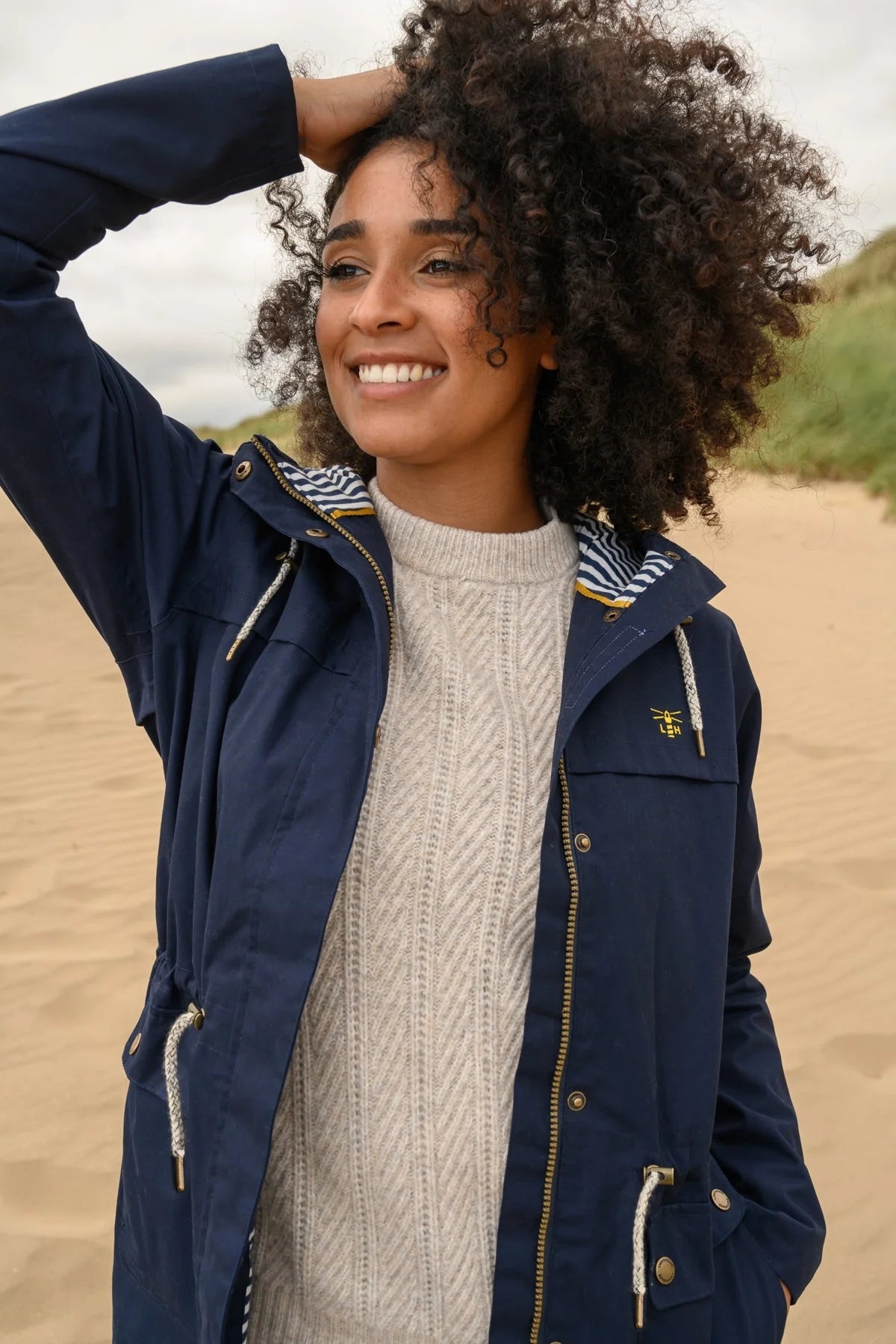 A waterproof womens rain jacket from Lighthouse in navy.
