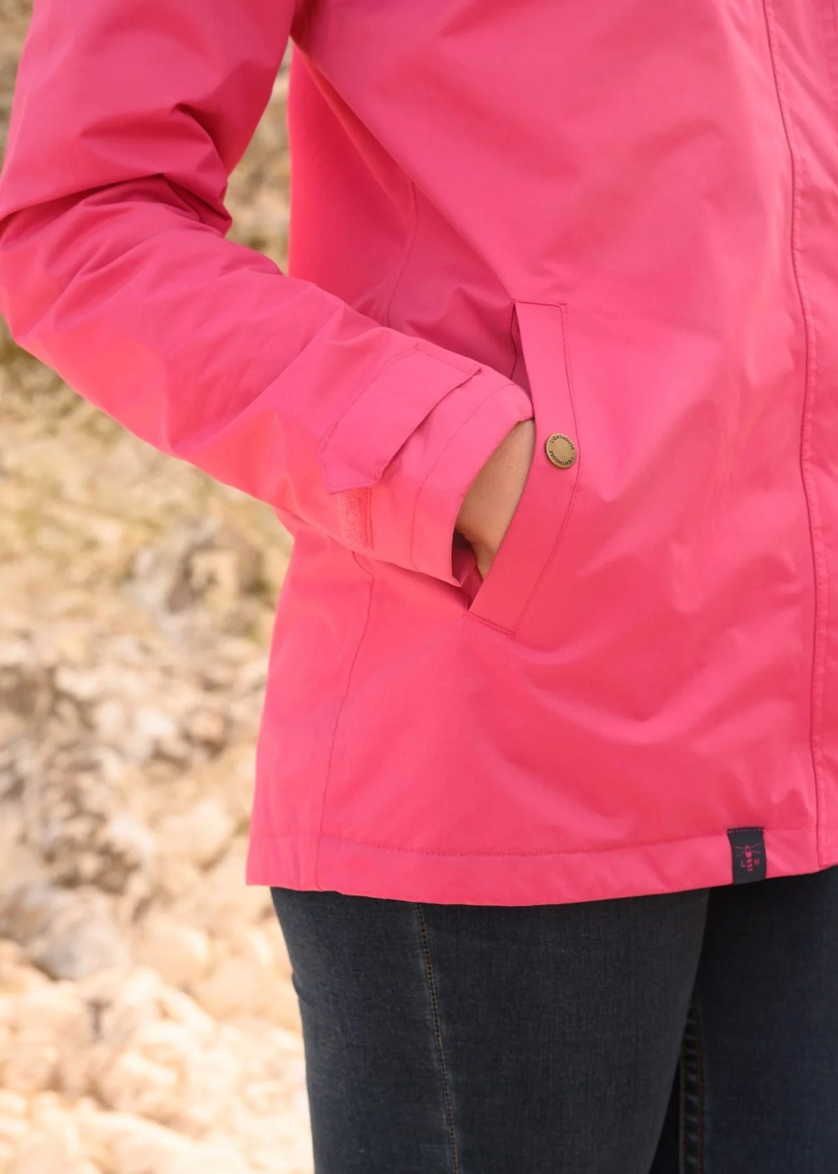 Lighthouse women's Beachcomber waterproof jacket in Pink with popper pockets.