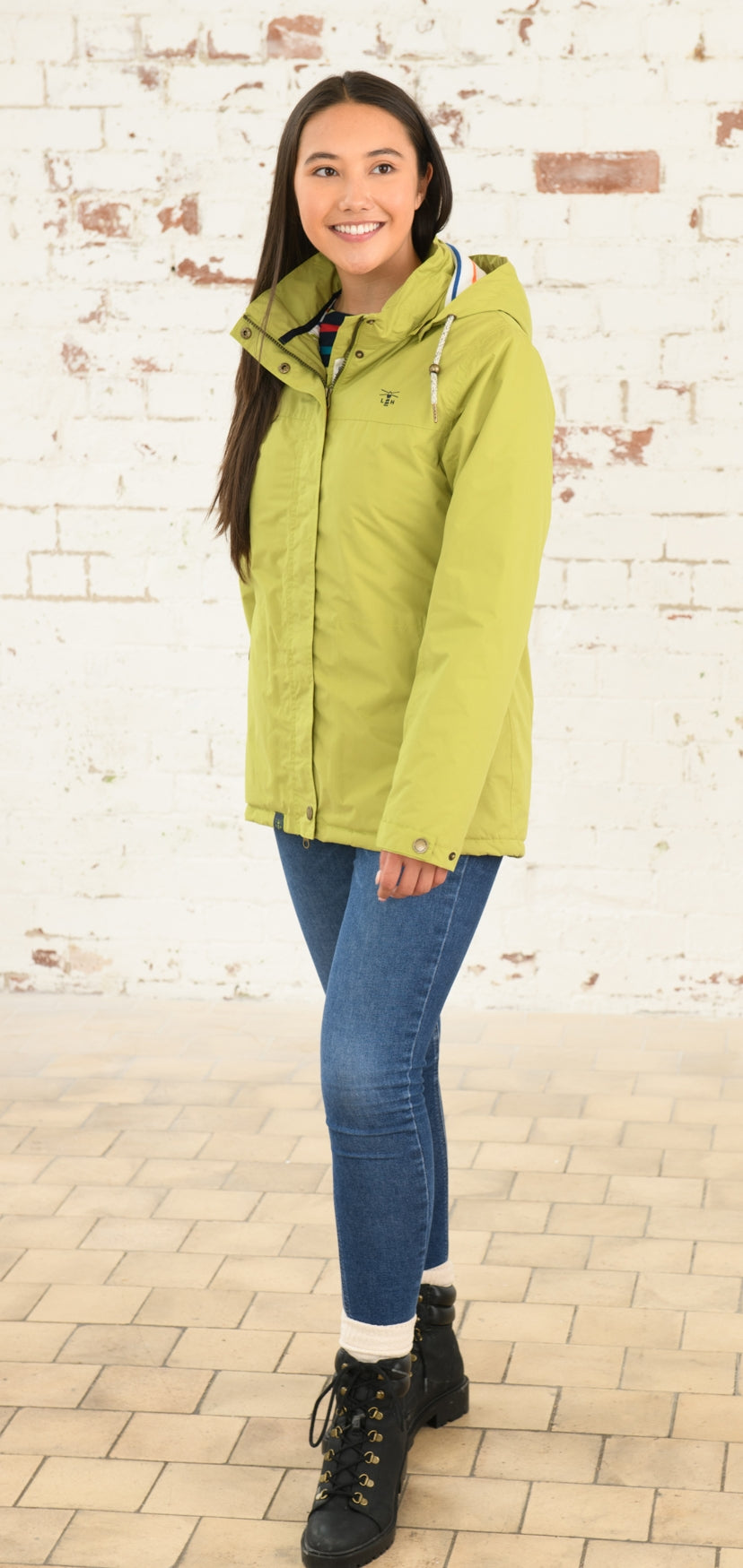 Women's padded waterproof Eva rain coat from Lighthouse in Apple Green.