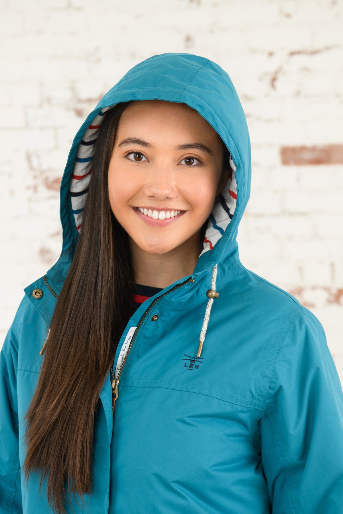 Women's hooded waterproof Eva Long rain coat from Lighthouse in Peacock.