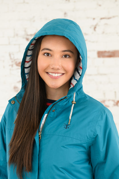 Women's hooded waterproof Eva Long rain coat from Lighthouse in Peacock.