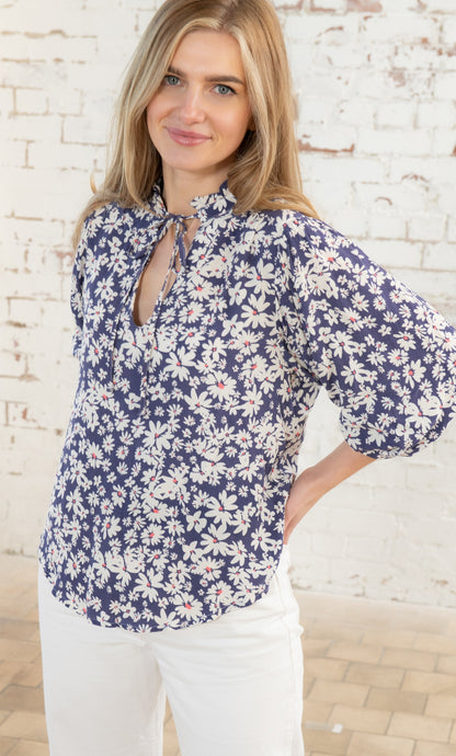 Ruched tie neckline women's Lola blouse from Lighthouse in indigo blue with white floral Daisy pattern.