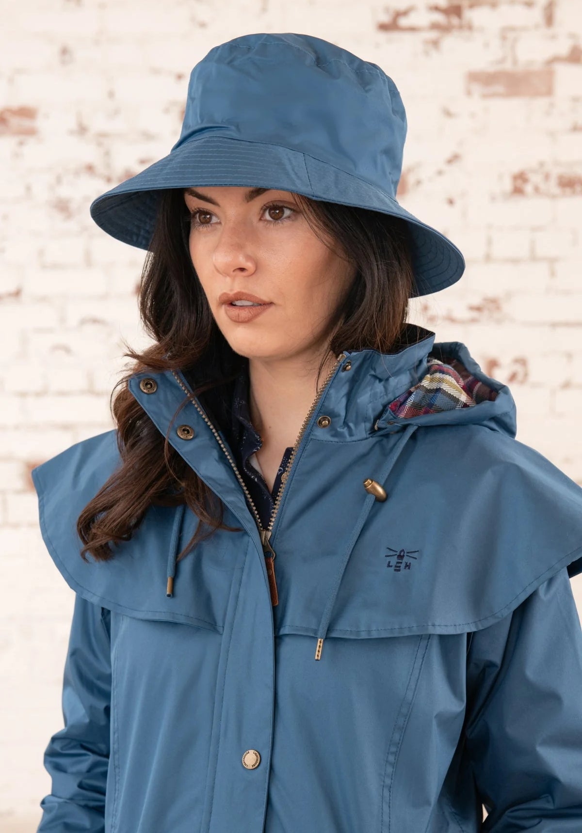 Adults waterproof Storm rain hat in Deep Sea Blue with a check pattern lining from Lighthouse. 