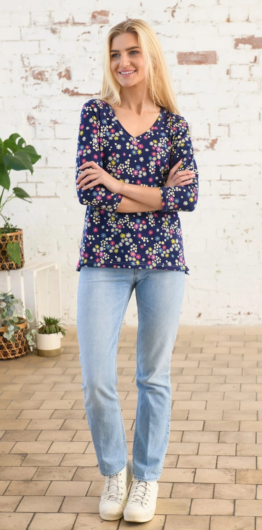 Lighthouse women's Ariana v-neck top in navy with a multicoloured floral Daisy print.