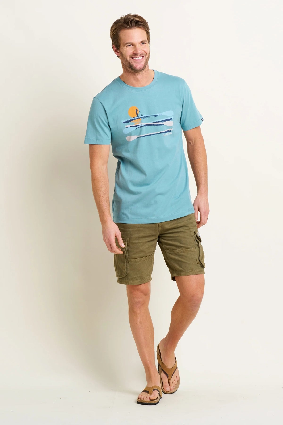 Mens Brakeburn paddleboard tee blue featuring paddleboard graphic worn with shorts and flip flops