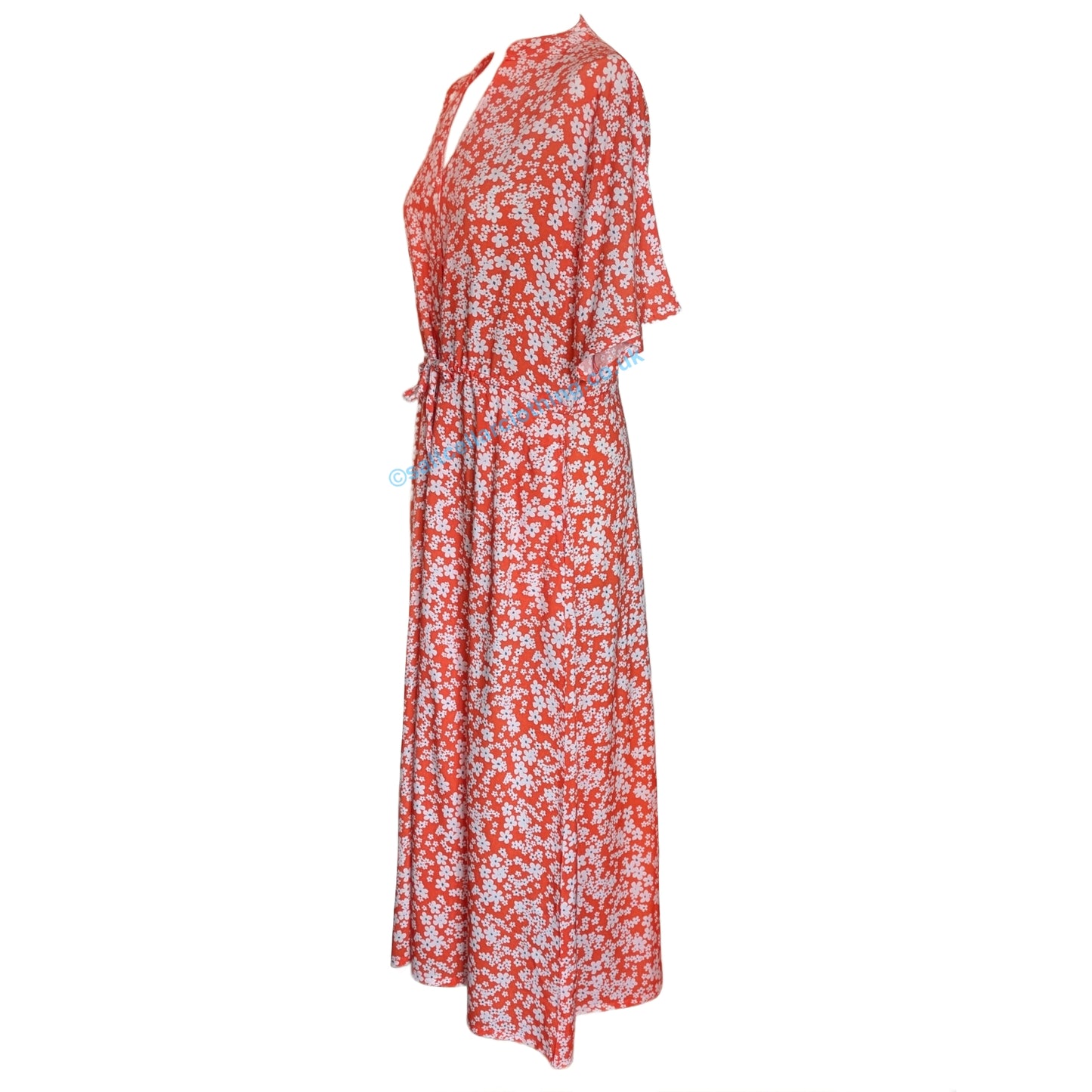 Side view of a womens Mudd & Water Alyssa short sleeve dress in coral with a floral print on a white background.