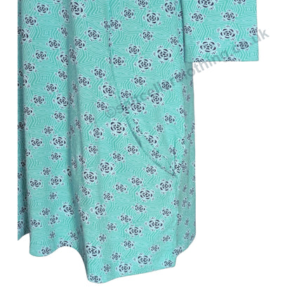 Close up view of a pocket on a womens turquoise Mudd and Water Francoise tunic with aa geo floral pattern on a white background