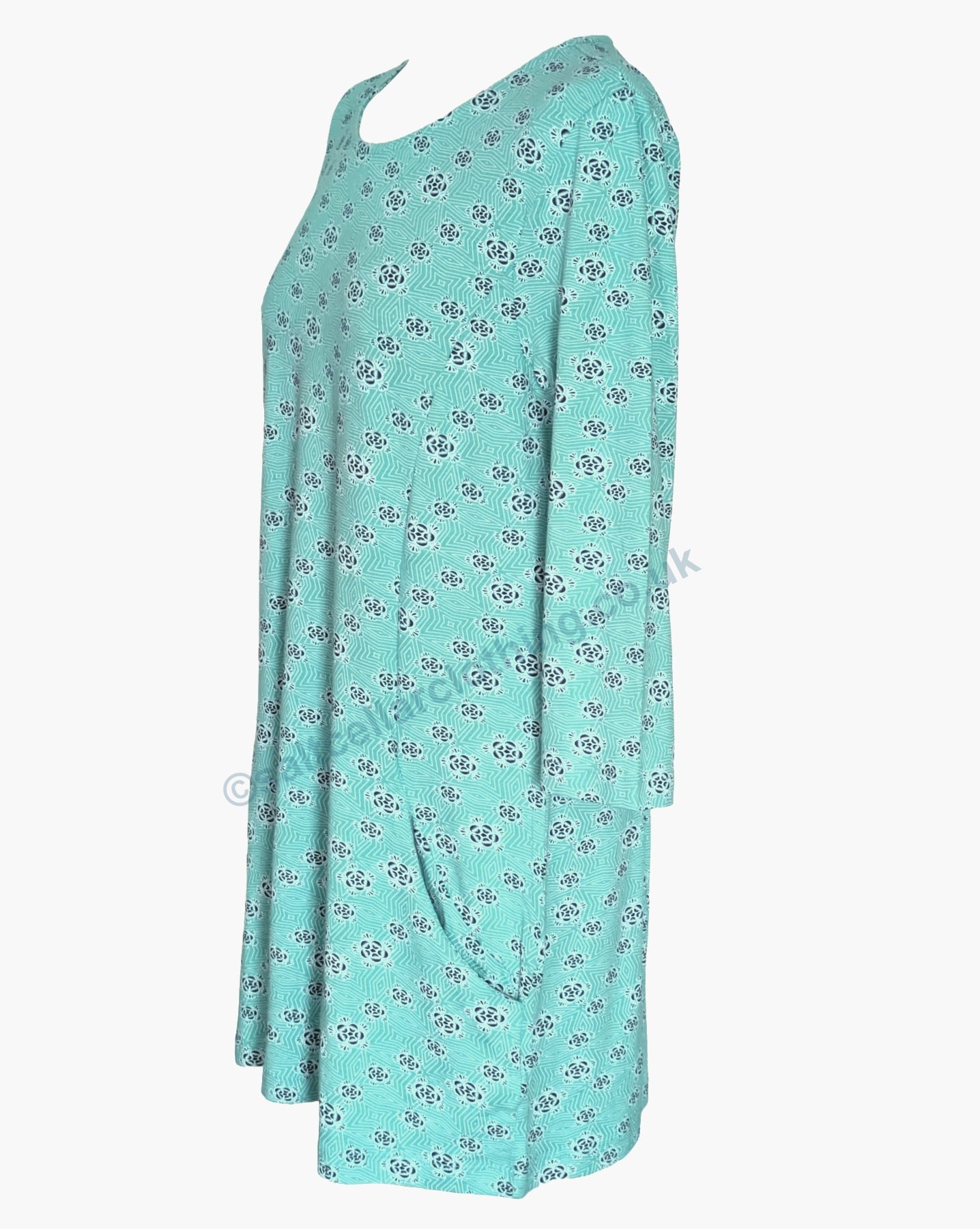 Side view of a womens Mudd & Water Francoise tunic with 3/4 length sleeves in Ceramic turquoise with a geo print on a white background