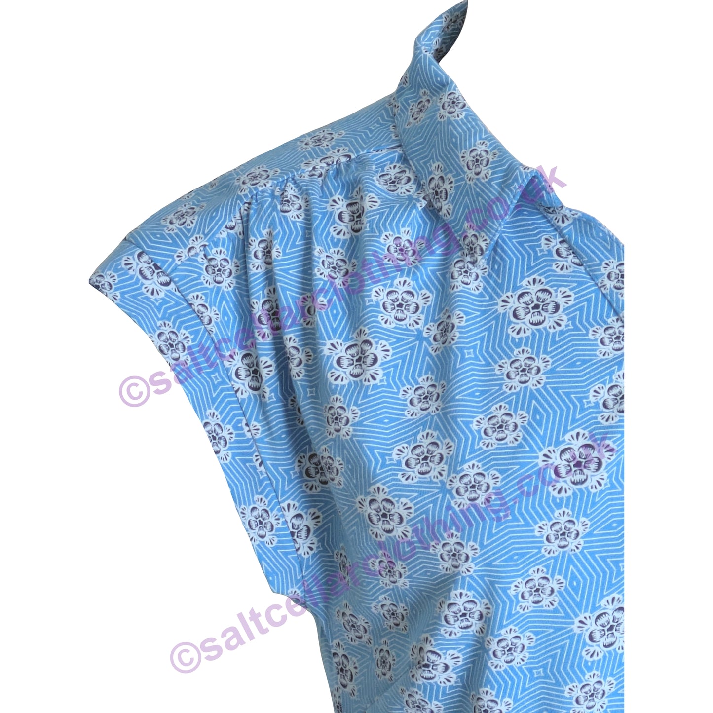 Close-up of shoulder pleat detail on a Mudd & Water womens Alice Top in Blithe Blue with a geometric floral pattern on a white background