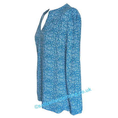 Side view of a womens Mudd & Water Bailey blouse in teal blue with white abstract pattern on a white background