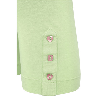 Close-up of Mudd and Water light green leggings with buttons on a white background