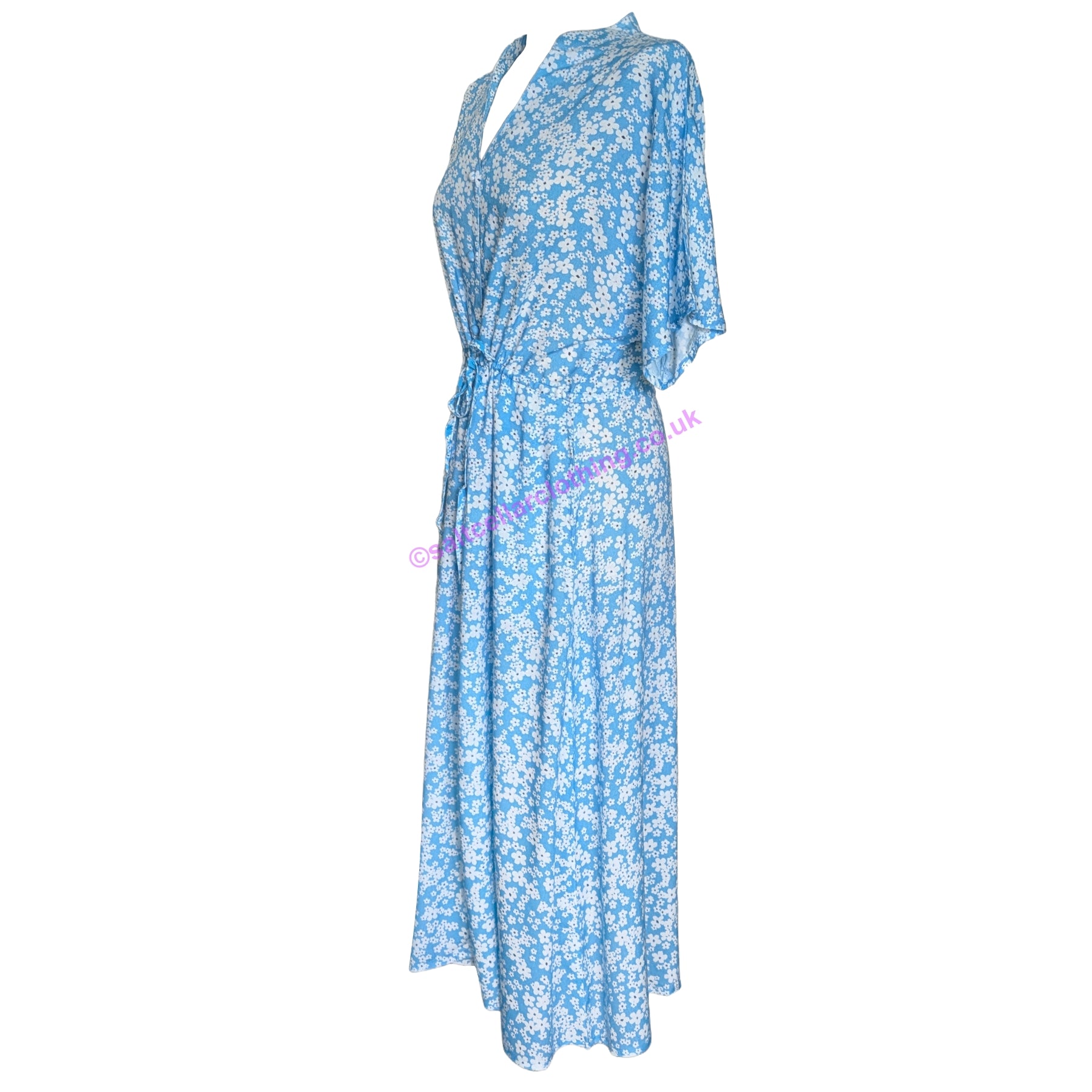 Side view of a womens Mudd & Water short sleeve blue floral Alyssa wrap dress on a white background